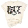 A grunge style peace, heart, and nursing cap with Easter accents in soft colors.
