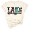 Hand drawn lake life western design with cowhide, aztec patterns, and arrows.