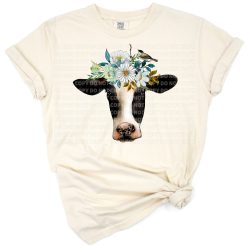 A hand drawn cow with a bird perched on its head and watercolor flowers around its neck.