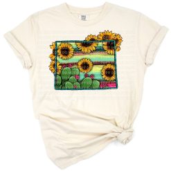 Illustrated Wyoming state map with sunflowers, cacti, and a colorful serape pattern.