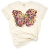 A watercolor butterfly surrounded by delicate pastel flowers and botanical accents.