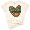 A pumpkin shaped like a heart with western style decorative accents.
