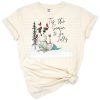 A funny snowman wearing a hat with a red cardinal perched on its arm, set in a festive winter scene.