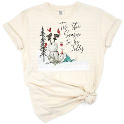 A funny snowman wearing a hat with a red cardinal perched on its arm, set in a festive winter scene.