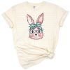 A pink watercolor bunny surrounded by farm and woodland animal elements in a soft, Easter-inspired style.