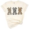 Three bunnies in leopard, cow, and giraffe prints with Easter accents.