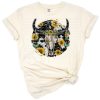 A bull skull adorned with sunflowers and cowhide accents in a western rustic style.