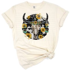A bull skull adorned with sunflowers and cowhide accents in a western rustic style.