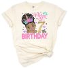 A cheerful girl with afro puff hair and a unicorn headband peeks out with birthday decorations.