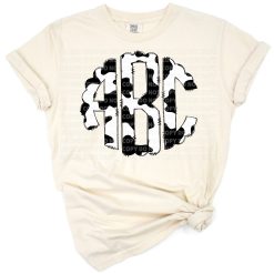 A set of stylized cow print monogram letters in a scalloped round and doodle style.