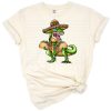 A cheerful dinosaur wearing a colorful Mexican hat in a western style artwork.