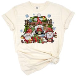 A cheerful Christmas gnome rides in a festive red truck with snowy holiday decorations.