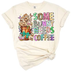 Cute bunny holding a coffee cup with spring florals and pastel accents.
