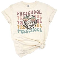 A retro style smiley face with leopard print design and playful grunge elements.