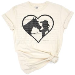 Cowgirl gently kisses a horse in a rustic country scene.