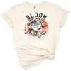 A retro-inspired vintage floral bloom with distressed accents in a shirt design.