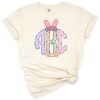 Hand drawn pink Easter bunny ears monogram letters with purple eggs in a cute doodle style.