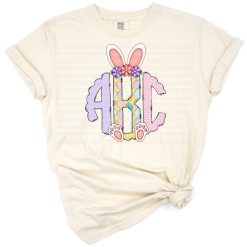 Hand drawn pink Easter bunny ears monogram letters with purple eggs in a cute doodle style.