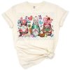 Three cheerful gnomes and a bunny surrounded by Easter eggs and pastel flowers.
