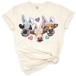 Hand drawn cows wearing bunny ears in a playful Easter scene.