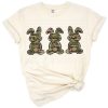 Three bunny rabbits in a row with army green camouflage patterns.