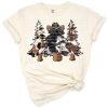 A group of Christmas trees decorated in cowhide and cheetah patterns with western flair.