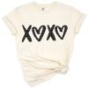 Handwritten XOXO with Cupid and heart accents in a playful Valentine’s Day motif.