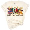 Peace symbol, heart, and festive Mexican elements in a colorful Cinco de Mayo themed design.