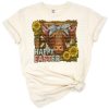 A highland cow with sunflowers and cactus in a colorful, boho Easter-themed composition.