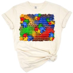 A colorful heart made of puzzle pieces with a love and acceptance theme.