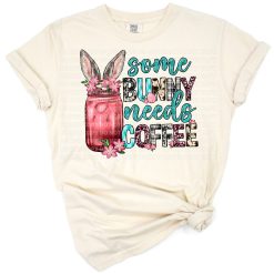 A cute bunny holding a coffee cup surrounded by spring and Easter decorations.