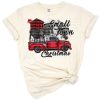 A festive red plaid pickup truck with a Christmas tree and holiday accents.