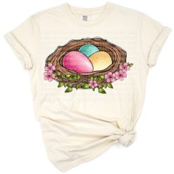 A cheerful bunny holding a coffee drink surrounded by pastel Easter decorations.