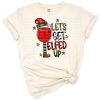 A playful Christmas elf with leopard and cowhide accents holding a festive drink.