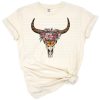 A boho Aztec-style western bull skull with decorative patterns and rustic elements.