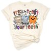 A spooky Halloween cartoon with smiling teeth, toothbrushes, and western accents in festive colors.