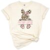 A hand drawn baby bunny with a bow surrounded by leopard and cheetah prints, perfect for Easter.