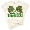 Skeleton hands holding green shamrocks in a playful St. Patrick's Day theme.