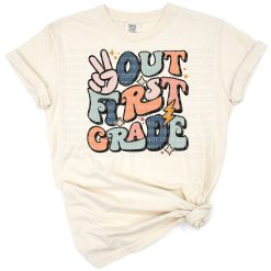 Colorful retro peace sign with first grade rainbow text and playful elements