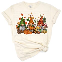 Whimsical autumn gnome with pumpkins and colorful fall leaves.