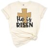 A decorative cross with the words 'He is Risen' in an uplifting Easter theme.