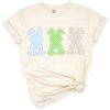 Three cute bunnies in blue, green, and beige sitting in a row.