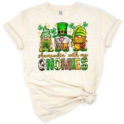 Three playful gnomes with green hats surrounded by shamrocks for St. Patrick's Day.