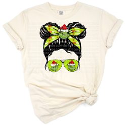 A whimsical green girl character in a festive Santa hat with playful holiday details.