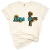 A unique western-style cross with gemstone and sunflower accents in a colorful, rustic design.