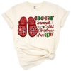 A cute illustration of holiday slippers surrounding a decorated Christmas tree.