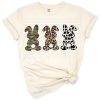A group of three bunnies with camo, leopard, and cow print patterns, perfect for Easter.