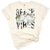 Retro summer sun with beach scene and vibrant colors.