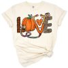 A cute pumpkin decorated with a nurse hat and surrounded by fall leaves.