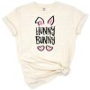 A cute pastel bunny with playful text surrounded by spring elements.